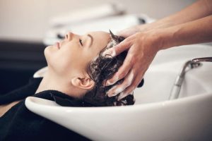 Woman having her hair washed in hair salon