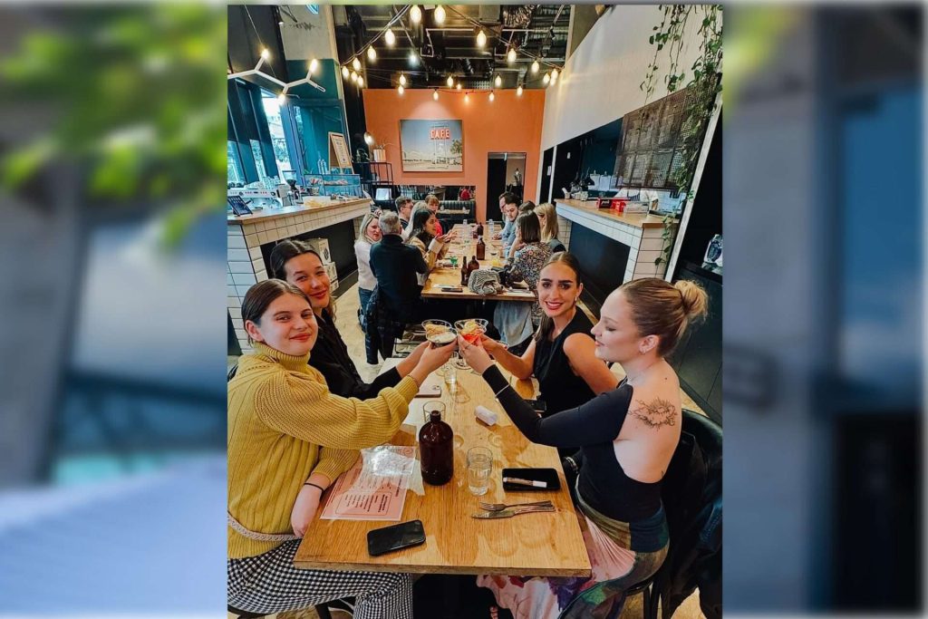 a group of people sitting at a table SOS Cafe South Yarra