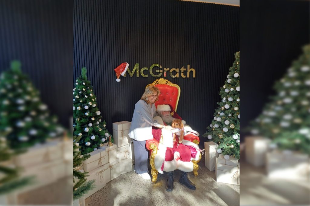 Woman and dog with santa at McGrath Real Estate South Yarra