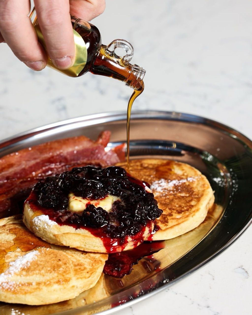 Saturday mornings in winter call for something warm and indulgent—like the maple and blackberry hotcakes at @normansouthyarra. Fluffy, golden and stacked with maple syrup, blackberry compote, and crispy maple bacon, it’s a cosy favourite that hits the spot as the weekend begins on Toorak Road.

📍2/300 Toorak Road South Yarra